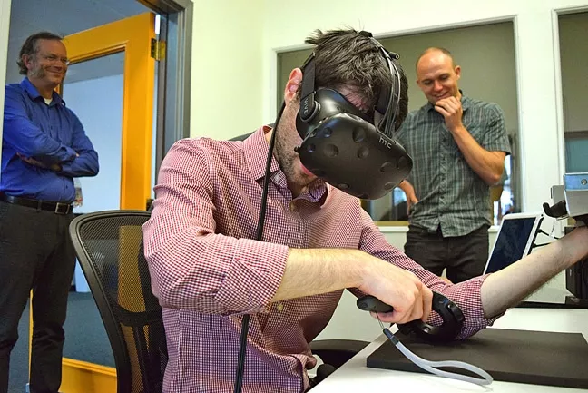 NEW TECH: AxonVR founder Jake Rubin hitches a virtual ride through reality in a demonstration of one of his company’s products. - PHOTO BY OLIVIA DOTY