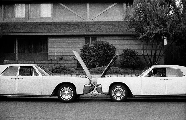 A CRASH OF SORTS: Local artist Erik Olson was inspired by the symmetry between two cars and the design of a house, which resulted in the photograph 'Two Lincolns One Guy.' - PHOTO COURTESEY OF ERIK OLSON