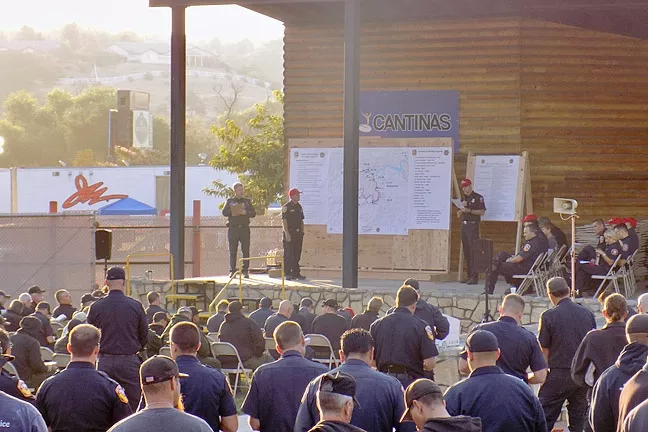 FIRE SEASON: Hundreds of firefighters attend an Aug. 17 Chimney Fire briefing at the Paso Robles Mid-State Fairgrounds. The fire has burned 7,300 acres south of Lake Nacimiento with 25 percent containment as of press time. - PHOTO BY PETER JOHNSON