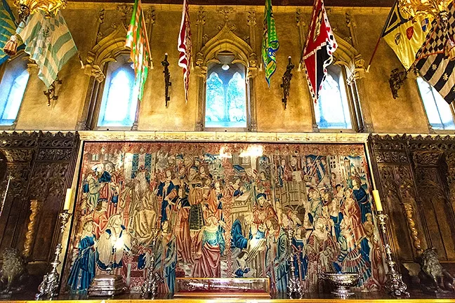 ART FOR DAYS: Silk flags representing different religious districts in Sienna and Flemish tapestries that are centuries old adorn the Refectory in Casa Grande. - PHOTO BY JAYSON MELLOM