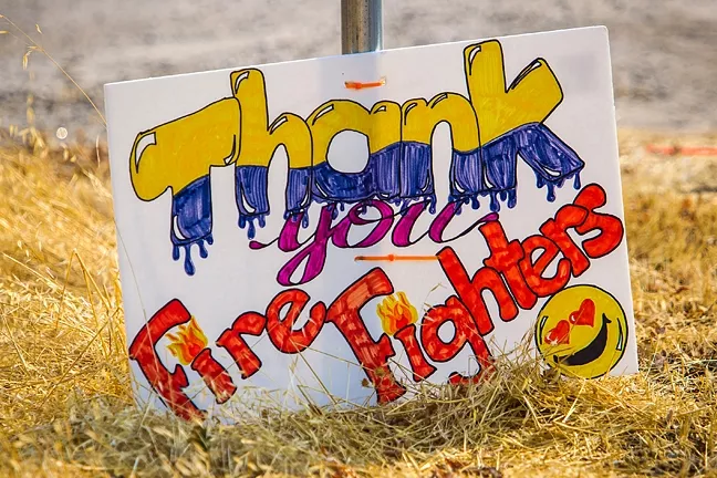 MANY THANKS: The community shows its gratitude to firefighters working the Chimney Fire with a sign along Nacimiento Lake Road. - PHOTO BY JAYSON MELLOM