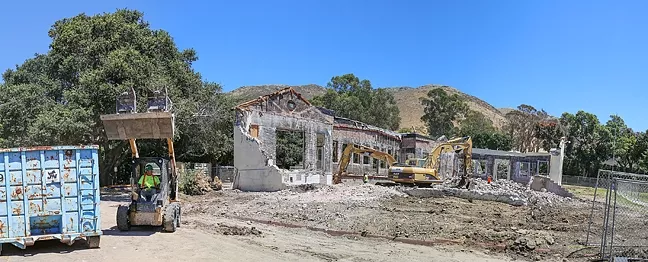 IN WITH THE NEW: Just weeks before school starts in August, construction workers tear down San Luis Obispo High School’s old annex building. In its place will be a new 12-classroom building. - PHOTO BY DYLAN HONEA-BAUMANN