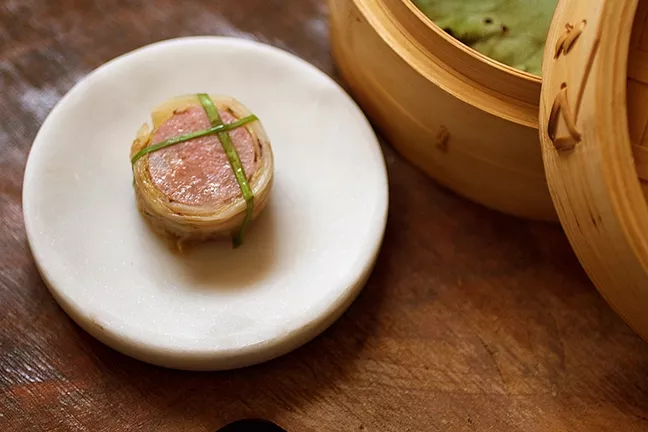 MANIACALLY CRAFTED: Pork and scallop sausage is served with carefully charred white kimchi. - PHOTO COURTESY OF SIX TEST KITCHEN
