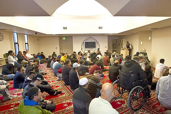 FAITH: Men who attend prayer at the Mosque of Nasreen sit in the front room of the Mosque while women watch prayer from a separate room. - PHOTO BY JAYSON MELLOM