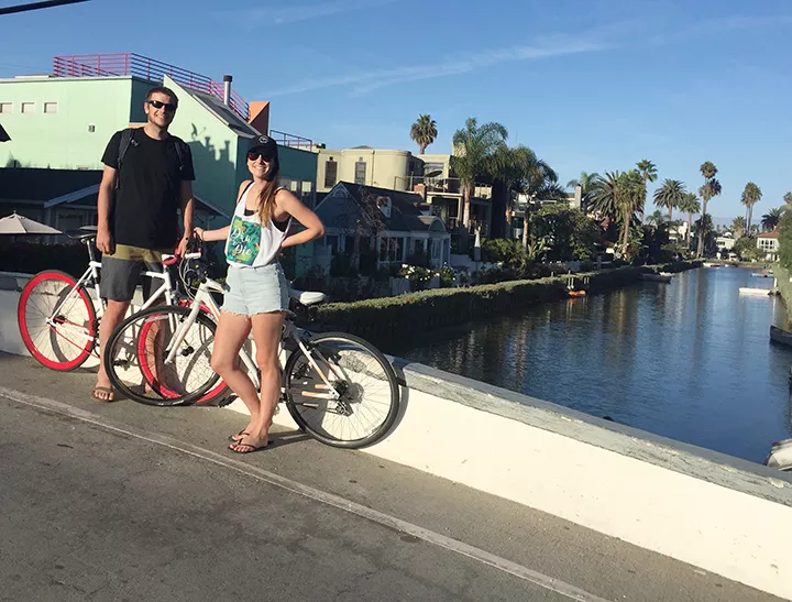 BRO AND SIS My sister, Lisa, and I stop our bikes for a quick photo next to the Venice canals. - PHOTO COURTESY OF JOHN STEIN