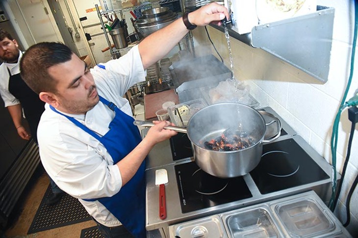 New head chef, Mitchell Dunzy, is busy preparing steamed mussels in the kitchen at Saints. - MARK HANCOCK