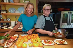 Kamala Gamble, left, with her chef Barbara Mock during food prep in her home recently. mh