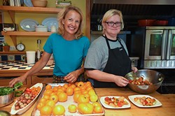 Kamala Gamble, left, with her chef Barbara Mock during food prep in her home recently.  mh