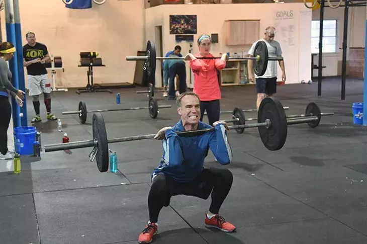 Patrons get into lifting barbells at all different weight levels at 405 CrossFit recently. mh