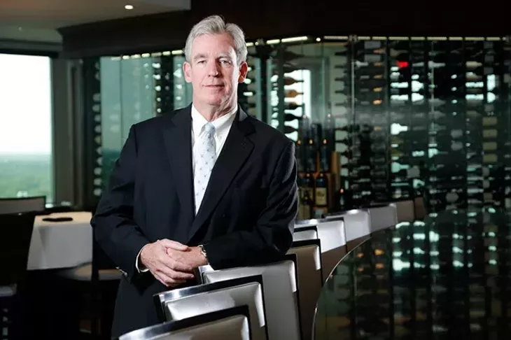 Kevin George pauses in front of the custom-built wall display of wines in The George Prime Steakhouse, his restaurant located atop Founders Tower. (Garett Fisbeck)