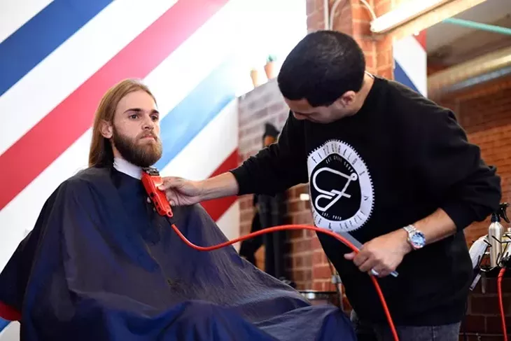 Phillip Jordan trims Joseph Thornburg's beard at Fitzgerald Barber & Supply, Tuesday, March 15, 2016. - GARETT FISBECK