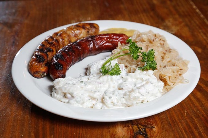 Regular and smoked brat with sauerkraut and potato salad at Old Germany in Choctaw, Thursday, Aug. 13, 2015. - GARETT FISBECK