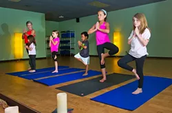 Denise Springer teaches a children's yoga class at You Power Yoga in Edmond.Photo/Shannon Cornman - SHANNON CORNMAN