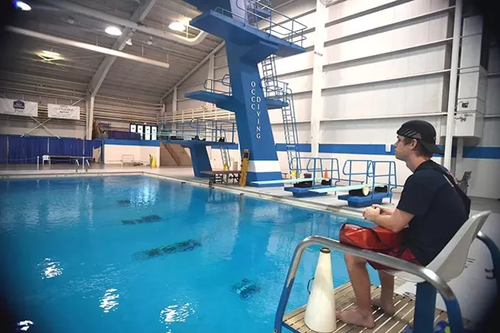 Colin Waldrop will be out of his lifeguard job when the OCCC Aquatic Center closes at the end of summer, shown in the seat in front of the OCCC Diving pool. mh