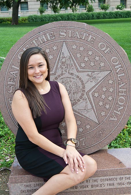 Oklahoma House District 85 candidate Cyndi Munson poses on the State Seal monument in front of the State Capitol.  mh