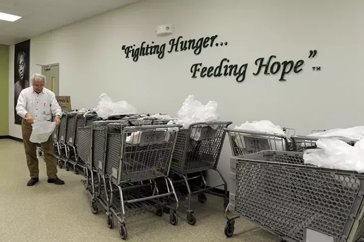 John Gorrell, a volunteer, prepares shopping carts at Skyline Urban Ministry in Oklahoma City, Monday, Nov. 24, 2014. - GARETT FISBECK
