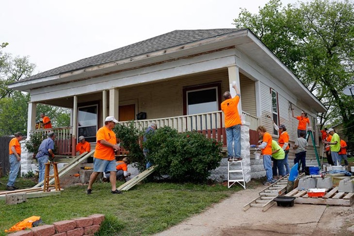Volunteers work during Rebuilding Day in the Classen Ten Penn neighborhood in Oklahoma City, Saturday, April 18, 2015. - GARETT FISBECK