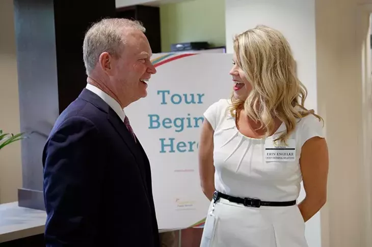 Mayor Mick Cornett talks with Erin Engelke during a grand opening ceremony at Sunbeam Family Services in Oklahoma City, Thursday, May 7, 2015. - GARETT FISBECK