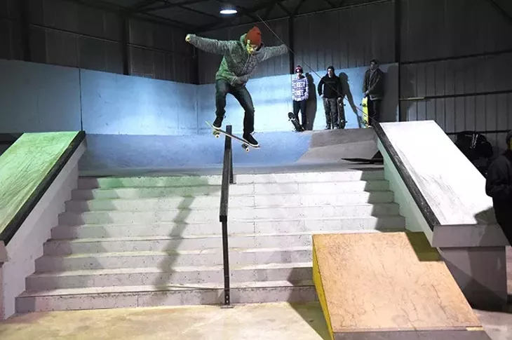 A skateboarder rides down a railing, inside the Industrial Skateboard Park, just south of Downtown Oklahoma City, 1-18-16. - MARK HANCOCK