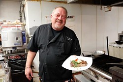 Chef and Owner Bruce Rinehart shows his plated steak in the kitchen at Rococco. (Garett Fisbeck)