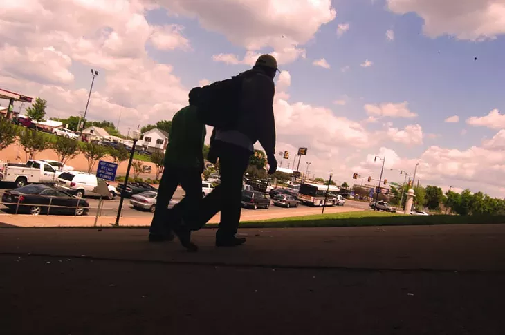 Two homeless men walk under the I-235 bridge and railroad tracks, which serve as a racial dividing line in Oklahoma City. - BEN FELDER