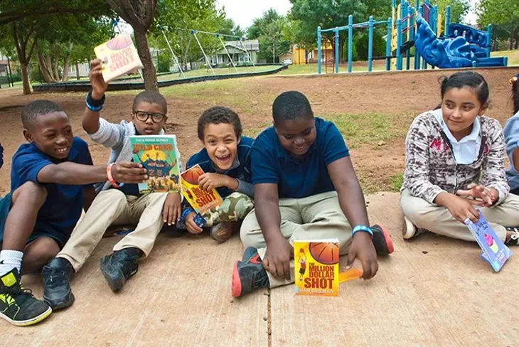 Putnam Heights Elementary students show the books they picked out inside the Rolling Thunder Book Bus, 9-11-2014. mh