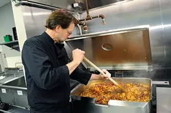Chef Kurt Fleischfresser preps lunch at WestTown day shelter in Oklahoma City, Tuesday, March 24, 2014. - GARETT FISBECK