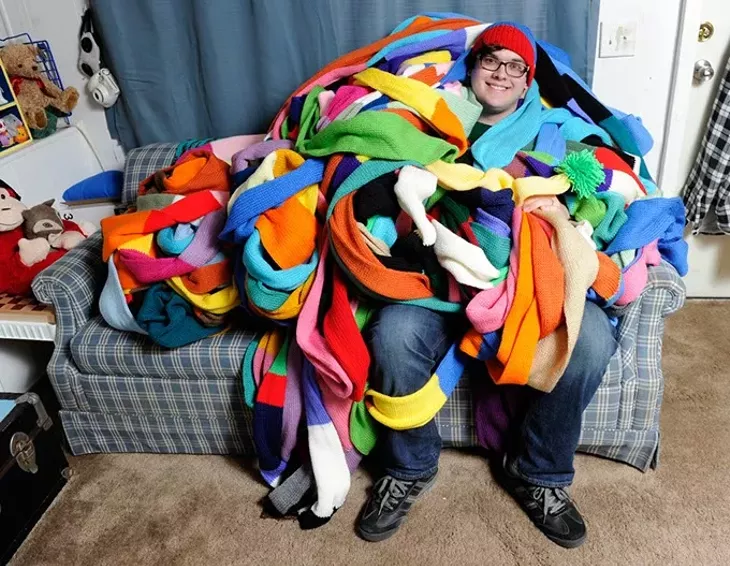 Aaron Miller poses for a photo with his 800-foot knit hat at his home in Oklahoma City, Friday, Jan. 29, 2016. - GARETT FISBECK