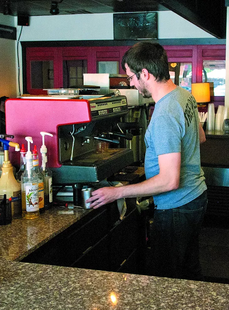 Jason Weigand works behind the counter at District Coffee House. (Mark Hancock)
