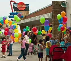Balloons outside Photo Art Studio add even more local color to Plaza Fest, celebrating it's 16th birthday Saturday.