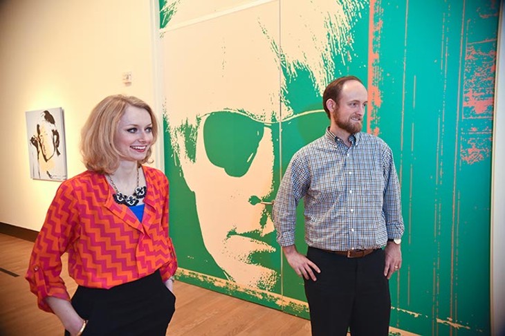 Kate Cunningham, a member of the Moderns OKCMOA group, admires works by Andy Warhol, part of The Athletes exhibit, next to Matthew Craig, a development assistant with the museum and liaison between the museum and the Moderns group, at the OKCMOA recently.  mh