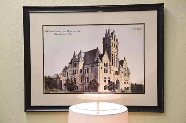 A postcard with an image of the original Oklahoma County Courthouse and Jail, hangs inside the County Office Building in the Engineering Department. (Mark Hancock)