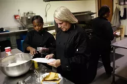 Myra Brooks, Tina McAtee, and Shelia Jackson work in a kitchen at TEEM in Oklahoma City, Thursday, Oct. 15, 2015. - GARETT FISBECK
