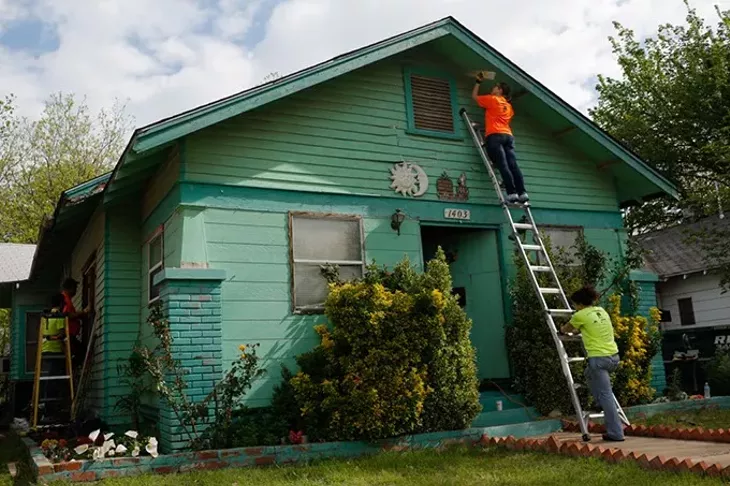 Volunteers work during Rebuilding Day in the Classen Ten Penn neighborhood in Oklahoma City, Saturday, April 18, 2015. - GARETT FISBECK