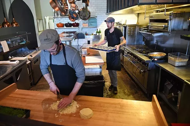 Alex Moyer chops some cheese as Jonathan Stranger works in background, at Ludivine, 9-21-2015. - MARK HANCOCK