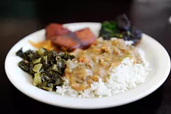 Crawfish ettouffee, collard greens, blackened pork chop, candied yams, at Cajun King in Oklahoma City, Monday, Dec. 14, 2015. - GARETT FISBECK