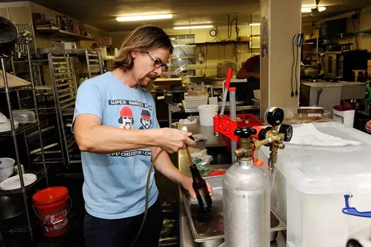 Jared Toay bottles a probiotic soda at Urban Agrarian in Oklahoma City, Thursday, Oct. 22, 2015. - GARETT FISBECK