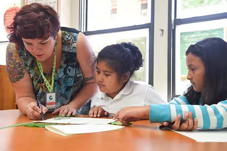 Left to right, Kristina Haden assists 4th graders Miriam Montante, and Jasmine Alcantara during an after school art program at Lee Elementary School in south OKC, 9-14-15. - MARK HANCOCK