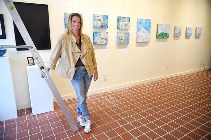 The Project Box Paseo gallery owner, Lisa Jean Allswede with new art by poet artist Kerri Shadid ready for the First Friday Gallery Art Walk on The Paseo, 10-1-15. - MARK HANCOCK