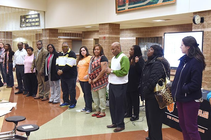 People participate in an exercise to illustrate "Students left behind" while attending The Great Conversation public meeting held at Fredrick A. Douglass High School, Monday, 3-2-15.  mh