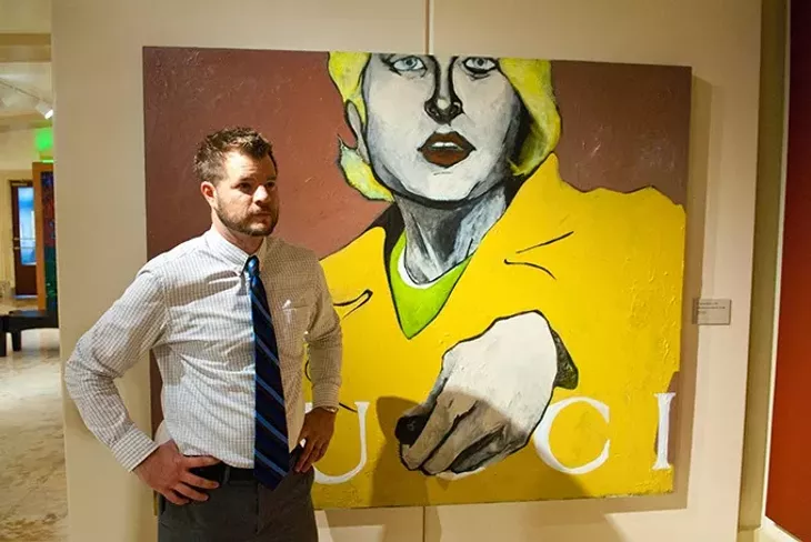 Joel Gavin of the Oklahoma State Arts Council with "A Mercedes is for People Like Us", by W. Bennett Berry, at the Oklahoma State Art Collection gallery, first floor of the State Capitol. mh