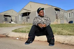 Jabee poses for a photo in front of a duplex where he lived in Oklahoma City, Wednesday, Dec. 2, 2015. - GARETT FISBECK