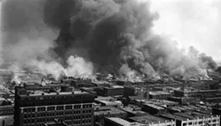 2006.75.01 Says on back - Burning of "Little Africa" the negro sction of Tulsa, OK during the race riot, June 1, 1921. About 30 were slain, 9 white, the balance negroes. This picture taken from the roof of the Cosden Building, 14 stories.