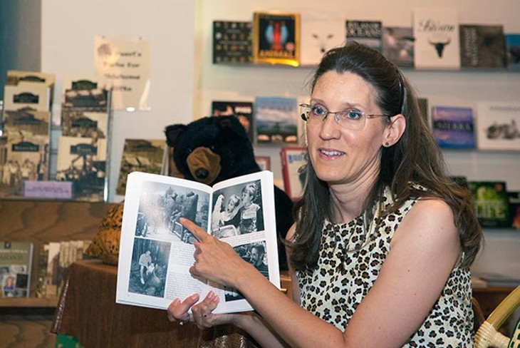Amy Dee Stephens discusses a picture in her new Oklahoma City Zoo book, Sunday, 8-24-14, during a book signing event at Full Circle Bookstore. (Mark Hancock)