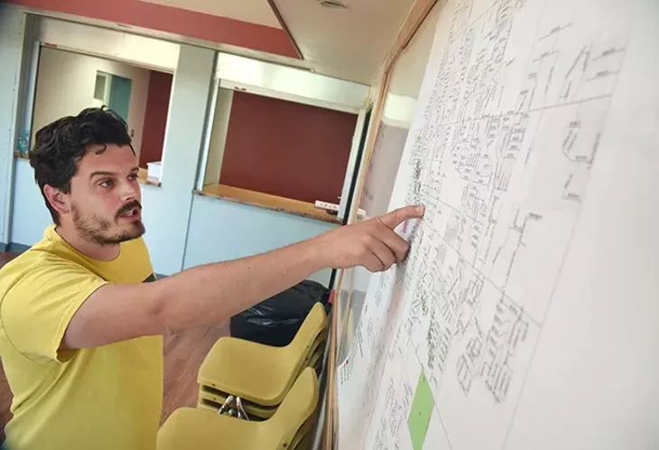 Chris Fox points out the preliminary damage assesment from Moore's recent March 25th tornado, plotted on a map at the Community Renewal Center where he serves as director of operations. mh