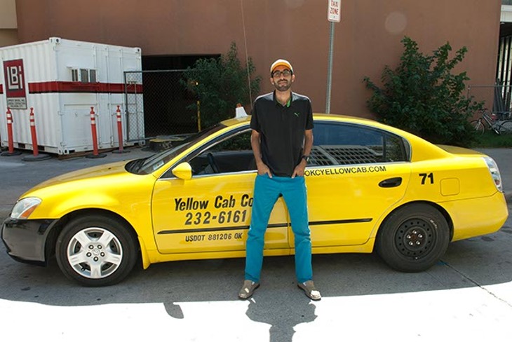 Yellow Cab driver, Abdul Nachi, poses in his waiting spot in downtown OKC. - MARK HANCOCK
