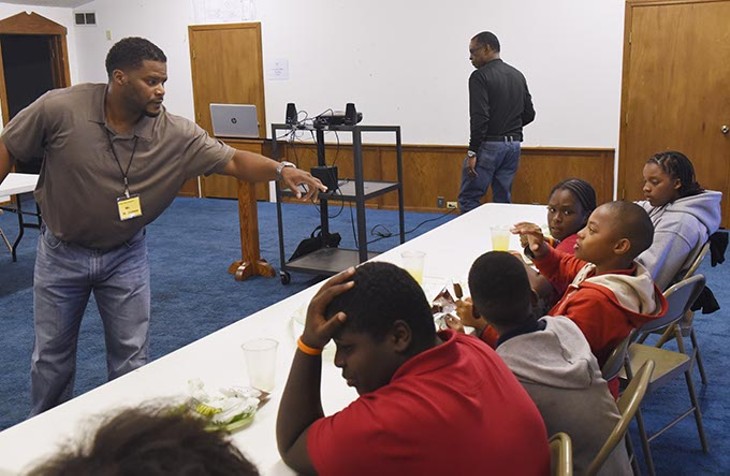 Marlon James works with boys during a group session at the Alpha Boys institute recently.  mh