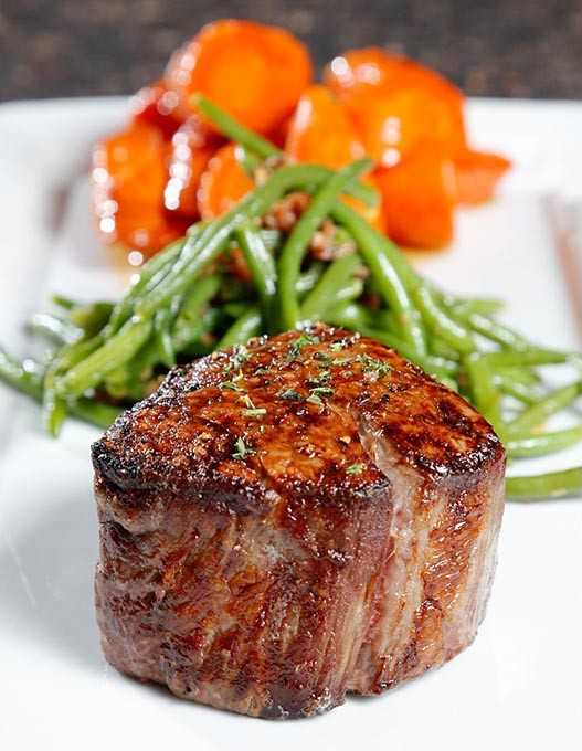 10 oz. Prime Filet with bacon green beans and glazed carrots at Ranch Steakhouse in Oklahoma City, Tuesday, April 14, 2015. - GARETT FISBECK