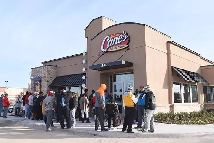 People waiting outside of the new, 250th Raising Canes restaurant in Midwest City for its Grand Opening, 12-10-15. The first 20 customers get free Canes once a week for a year. - MARK HANCOCK