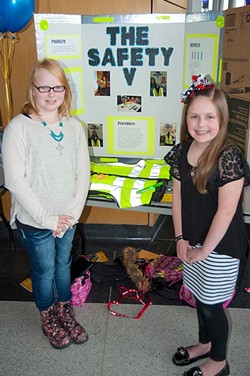 Last year&#146;s winners of the Oklahoma Student Inventors Exposition, Kylie Thompson, left, and Jadyn Waddle, both from Heritage Trails Elementary in Moore, are shown with their project. They created a tornado safety vest featuring a colored strobe light, alert whistle, glow sticks, identification holders and other useful implements which could be worn during severe weather. - KEN BEACHLER